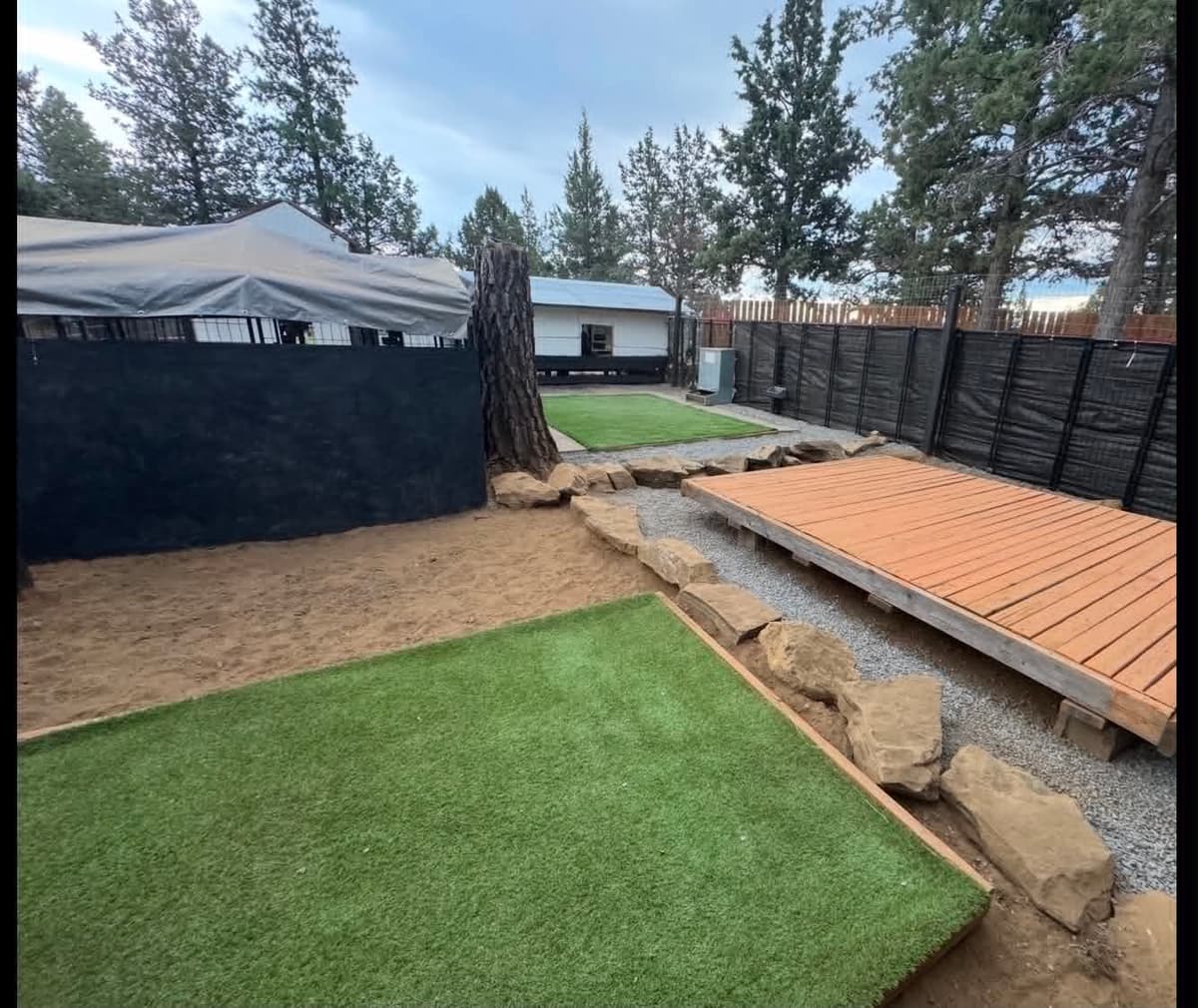 Turf exercise yards with shaded decking and secure fencing